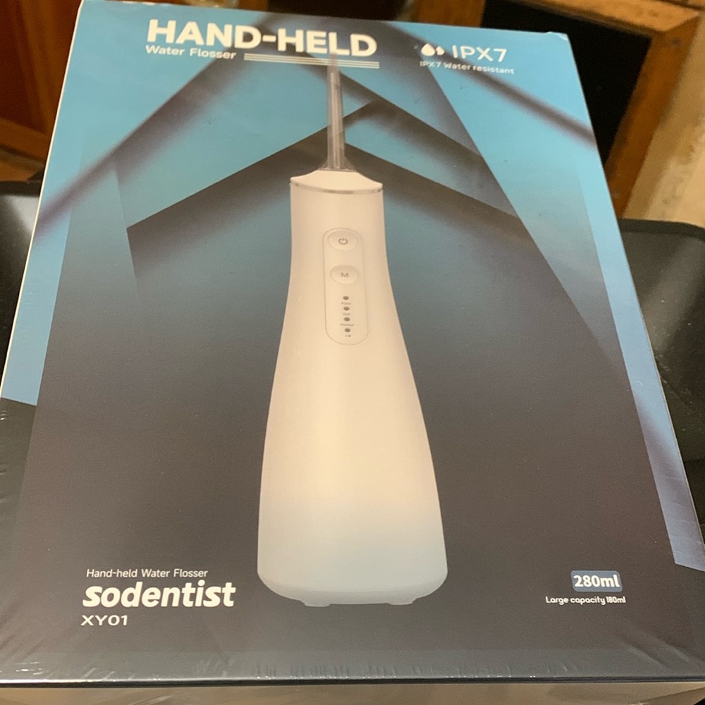 NIB Hand held water flosser